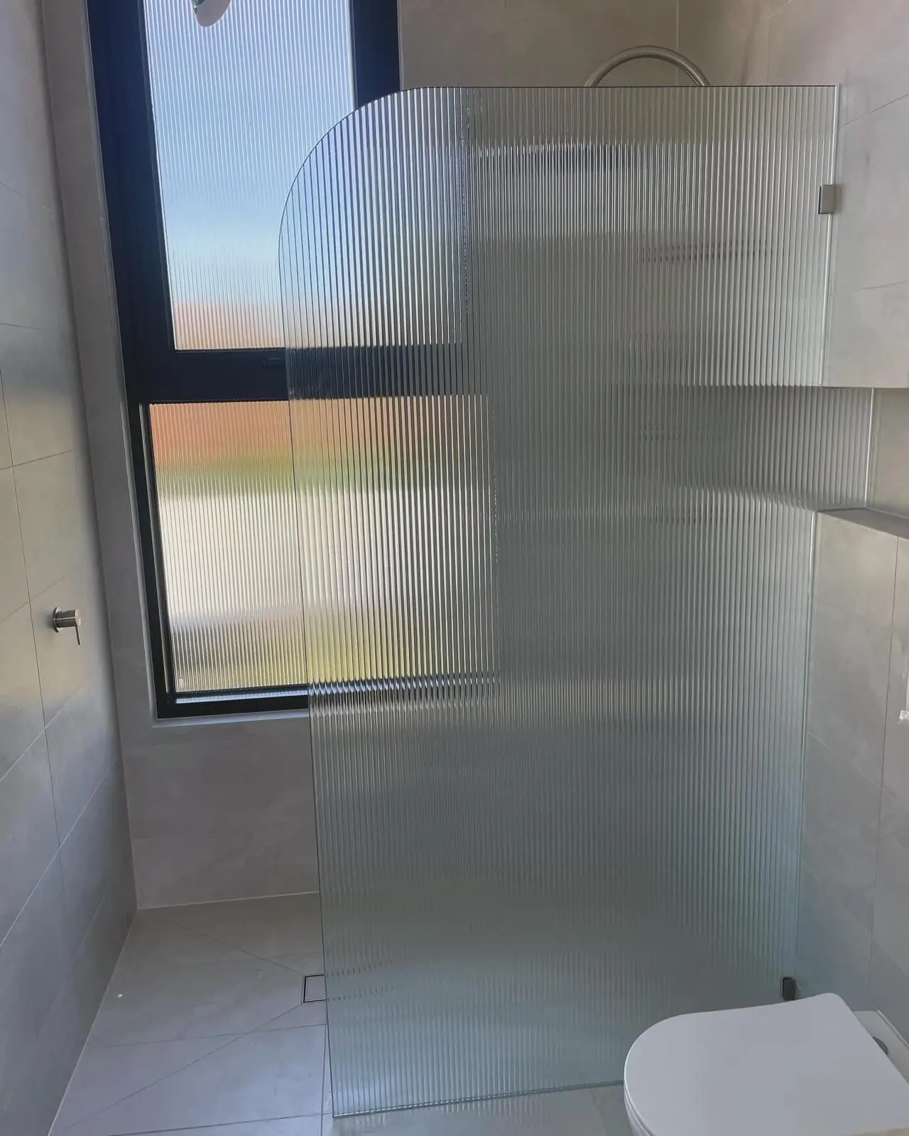 Frameless glass shower screen installed in a Cheltenham ensuite by Maison Glass & Aluminium